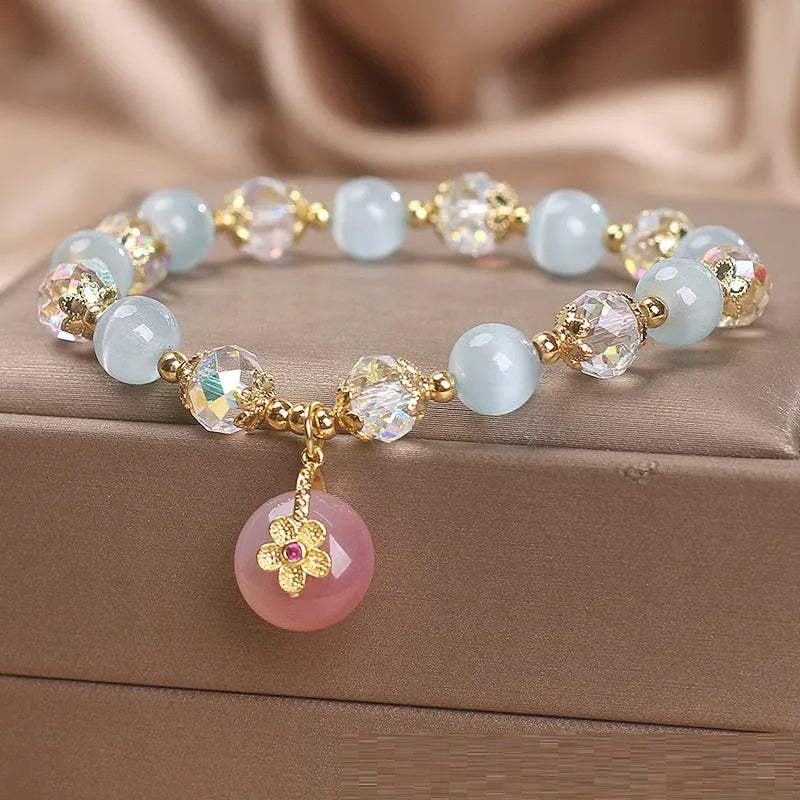 Chinese style sky blue opal peace buckle pendant bracelet for women on a flat surface