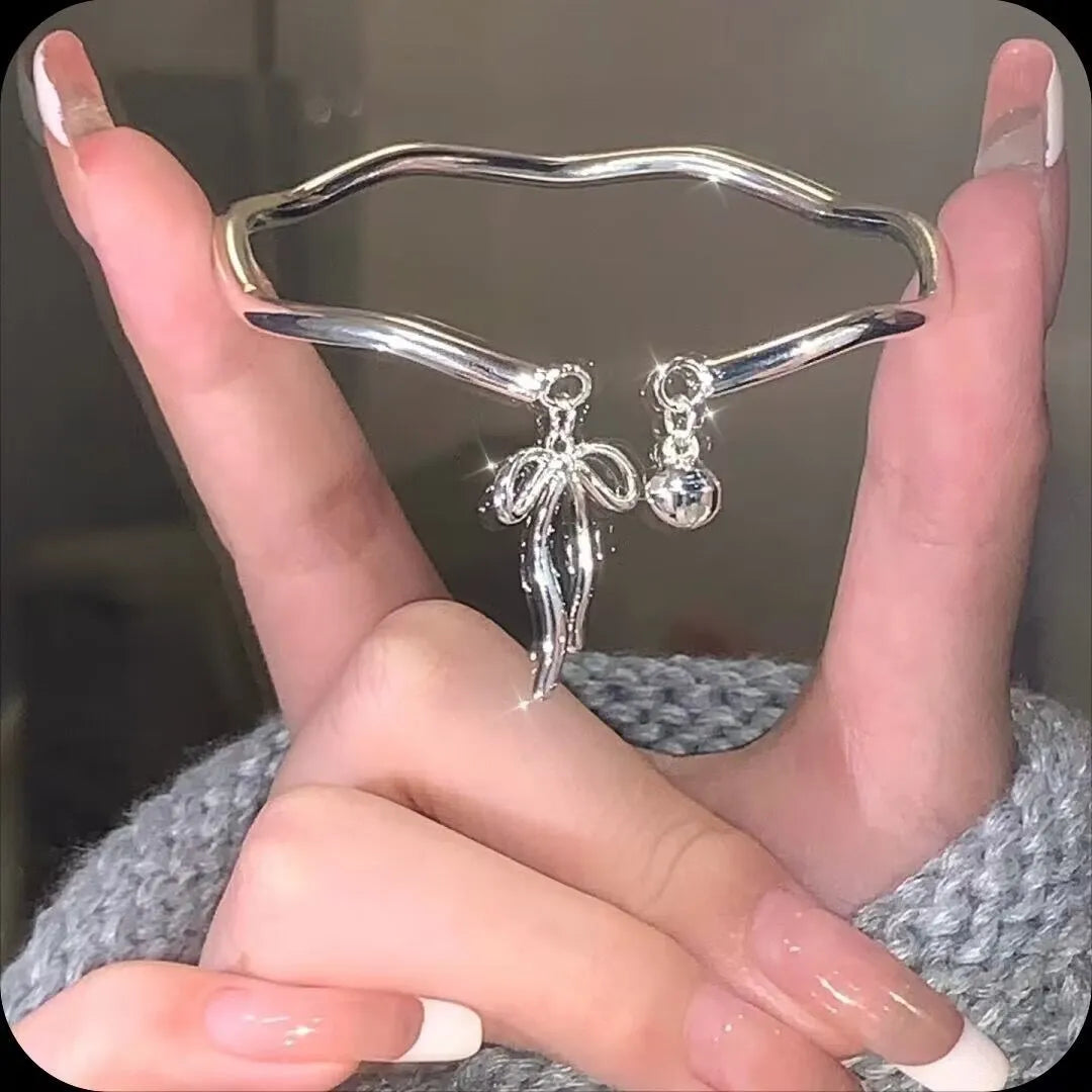 Silver bow adjustable girlfriends bracelet with bell opening clasp and sliding charm