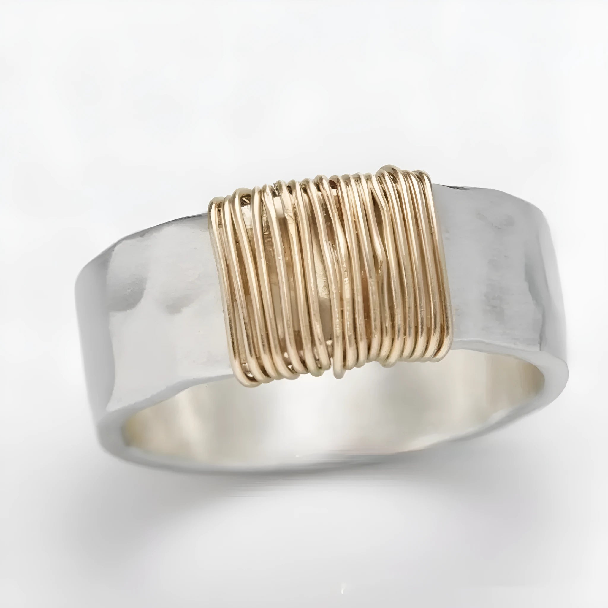 Copper wide face ring with irregular coil design in silver-gold colour.