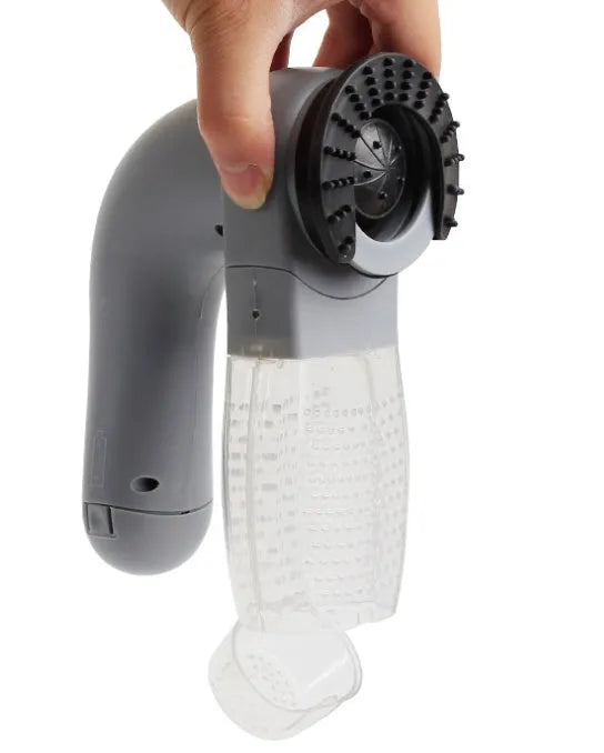 Grey portable electric pet hair removal brush with soft rubber head for grooming dogs and cleaning sofas.