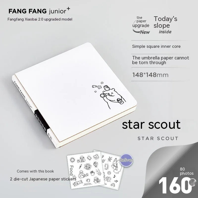 Small white square notebook with checkered pages and decorative sticker sheets