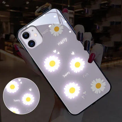 White luminous phone case with painted daisy design for Apple iPhone, showing voice-activated light feature.
