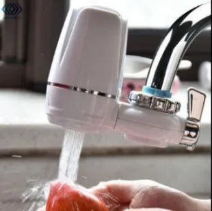 White plastic kitchen tap water filter with ceramic cartridge and installation adapters