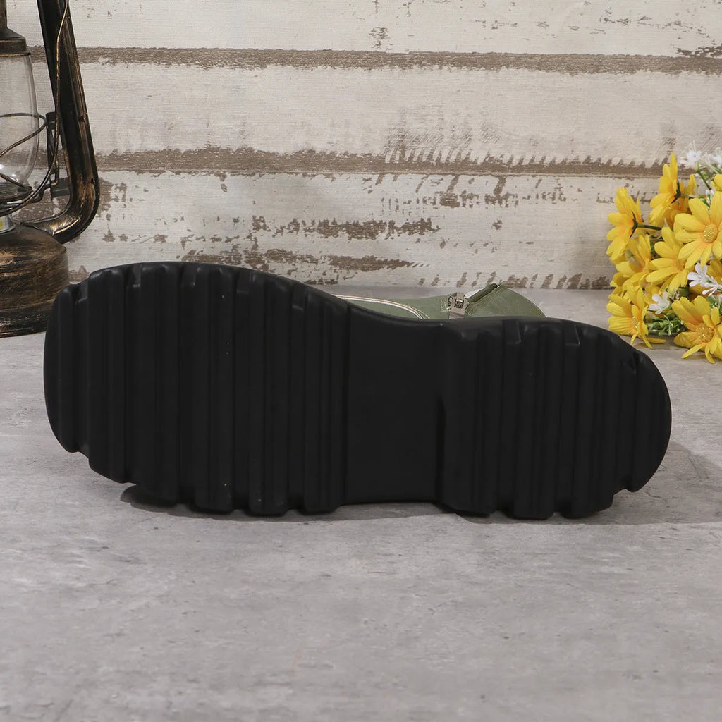 Women's black retro platform Martin boots with patchwork toe and side zip.