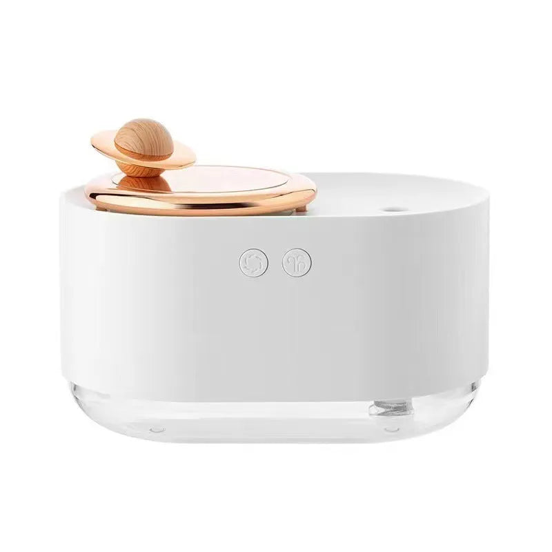 Green rotating planet-shaped USB humidifier with night light on a wooden desk.