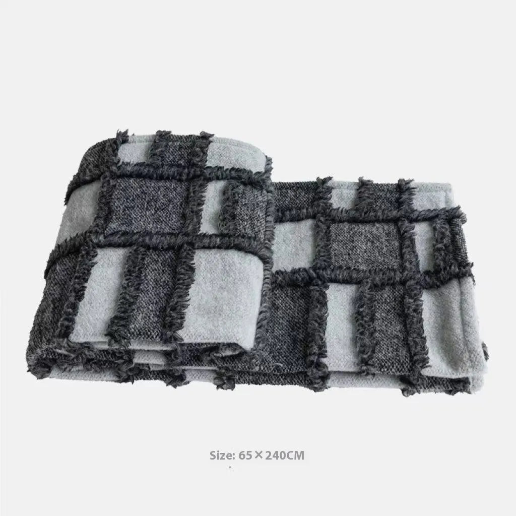 Modern minimalist grey and white plaid bed runner blanket set with matching pillow on a double bed