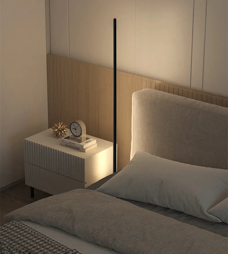 Vertical aluminium alloy floor lamp in modern simple style next to a sofa.