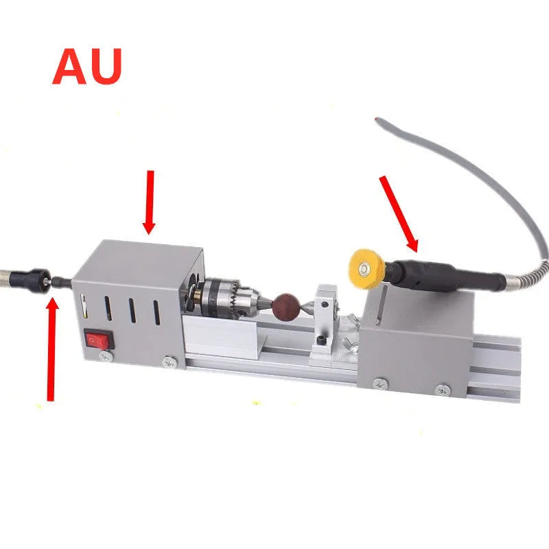 Mini silver metal woodworking lathe with carving knives on benchtop for small-scale turning projects