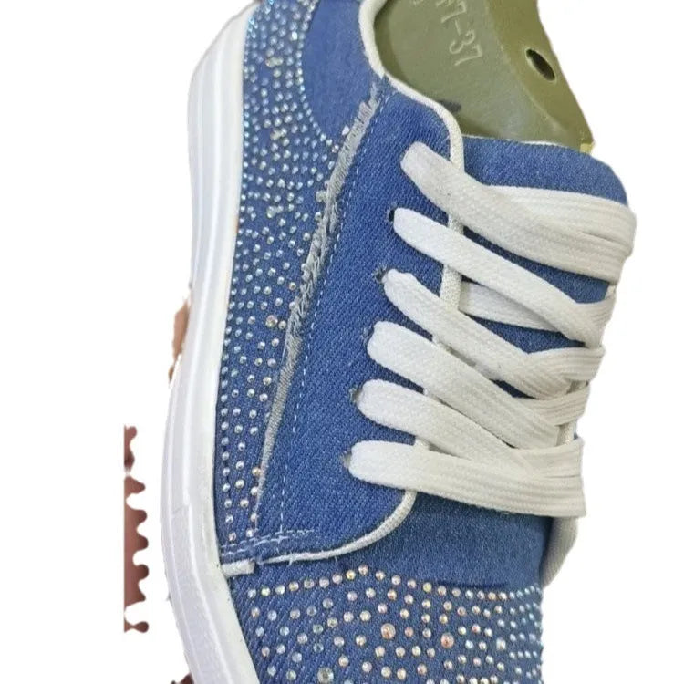 Women's black casual flat shoes with thick rubber sole, lace-up front, and rhinestone decoration.