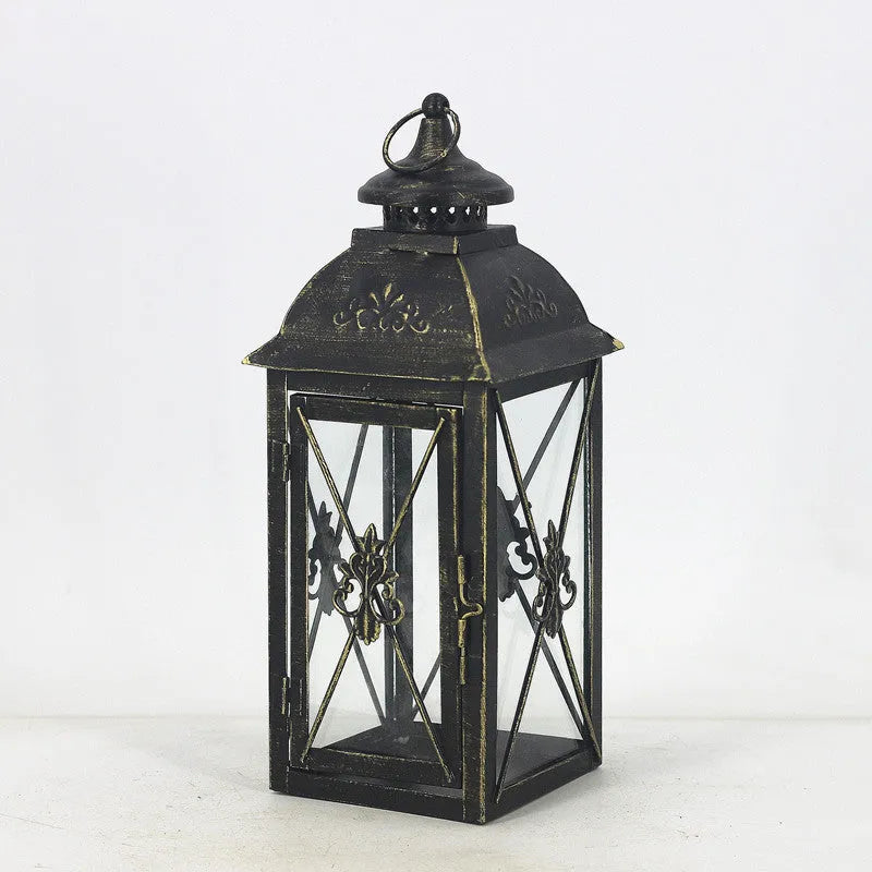 Black wrought iron floor-standing storm lantern with tempered glass panels for outdoor candle lighting