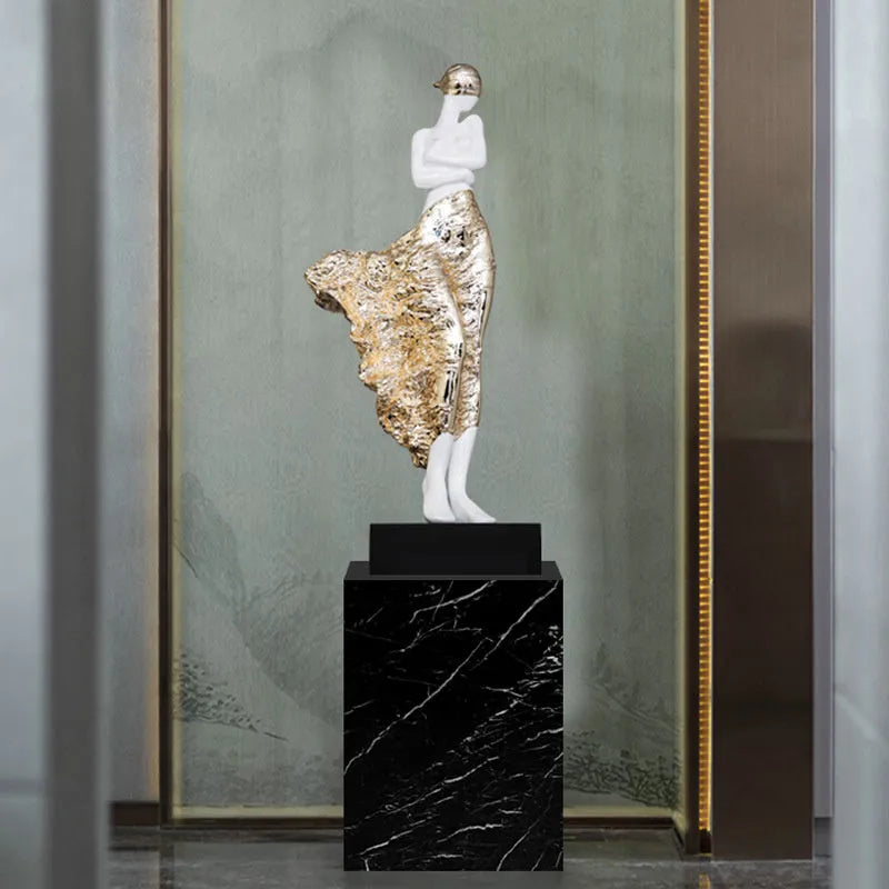 Tall metallic character sculpture ornament on a neutral background