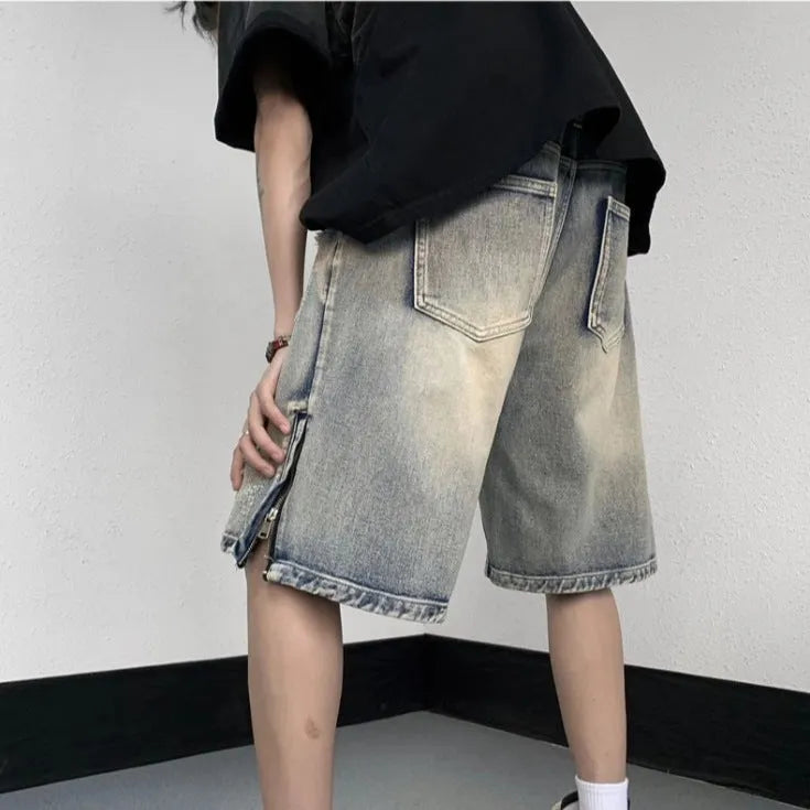 Blue retro-style denim shorts with a wide-leg loose fit and tattered details on a neutral background.