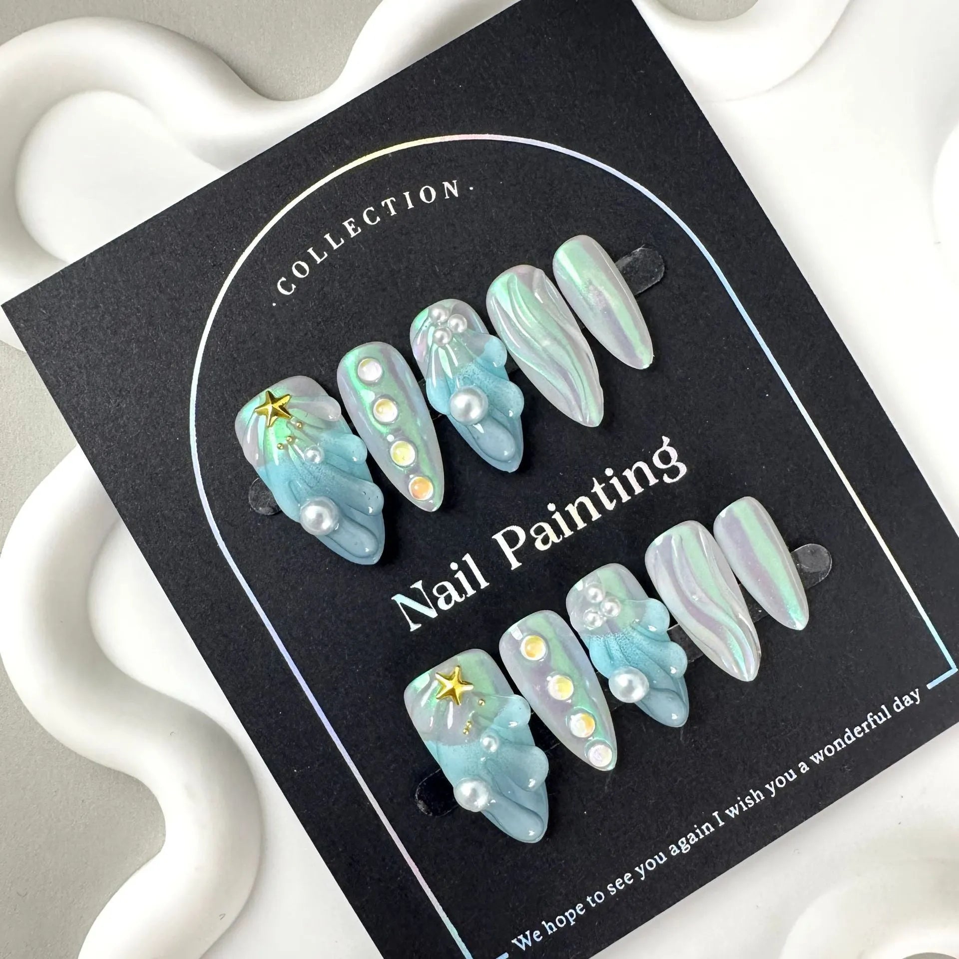 Blue plastic artificial nail tips laid out showing sizes XS S M L