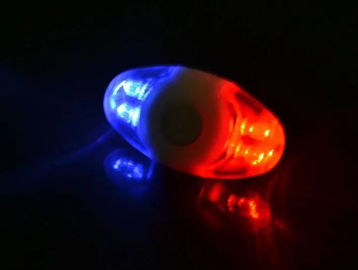 Red and blue LED bicycle tail light with adjustable mounting base showing horizontal and vertical positioning options