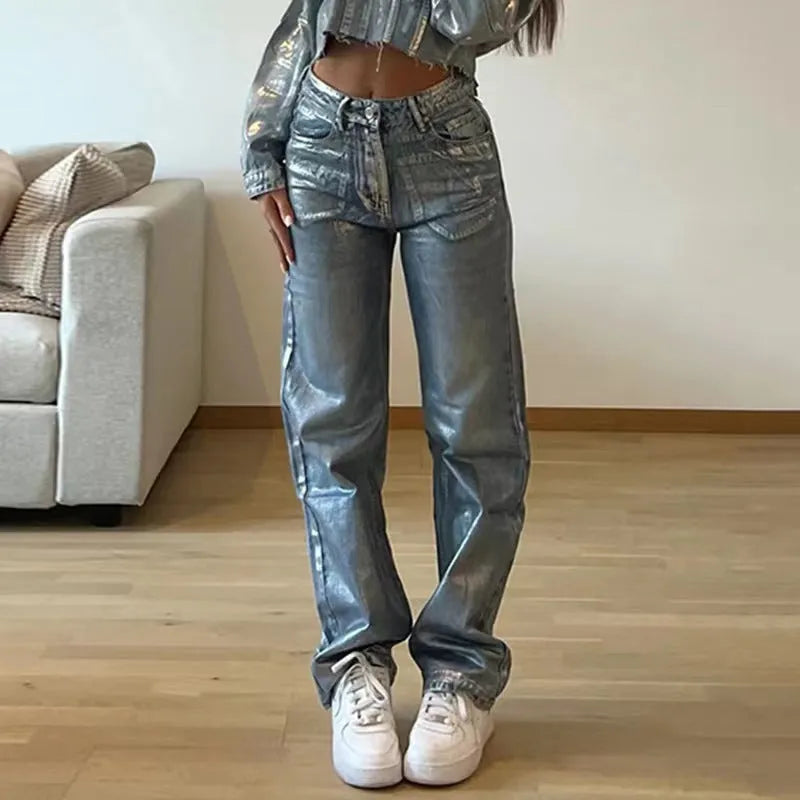 Washed blue high waist straight leg jeans on a model, showing contrast colour details.