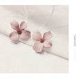 Flower shaped stud earrings for women in white or pink electroplated alloy