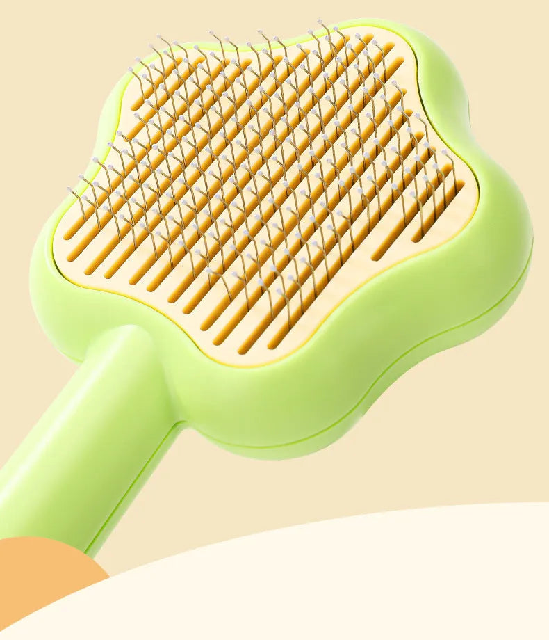 Green self-cleaning stainless steel pet comb with a magic wand handle on a white background.