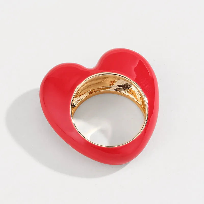 A heart-shaped three-dimensional enamel ring in zinc alloy, shown in one of four available colours.