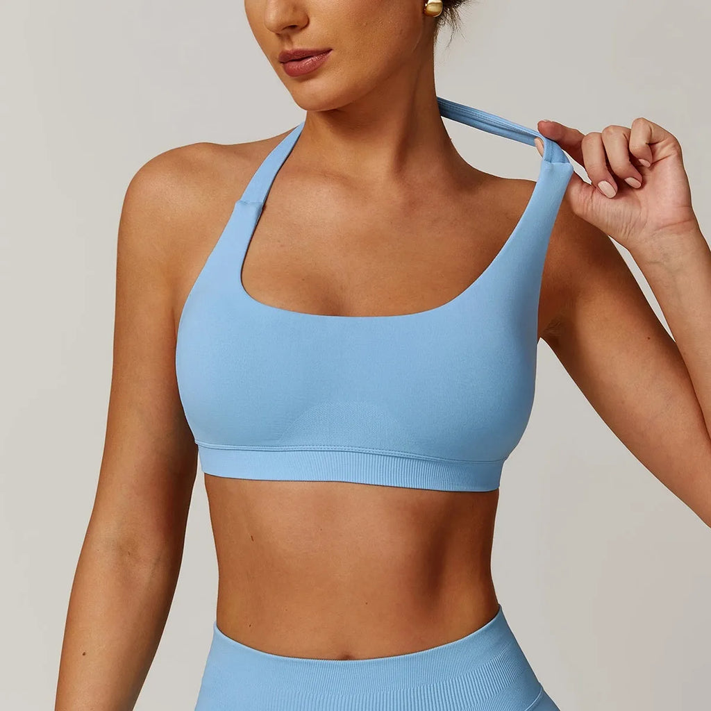 Women's black halter neck nylon sports bra for yoga and workouts on a mannequin.