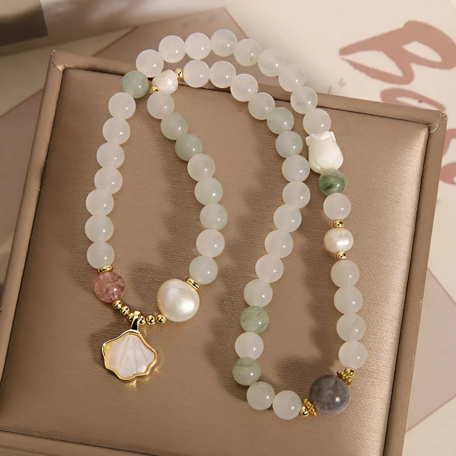 Women's crystal bracelet with an apricot leaf pendant and gold-plated gemstone accents in a green Tianshan jade colour.