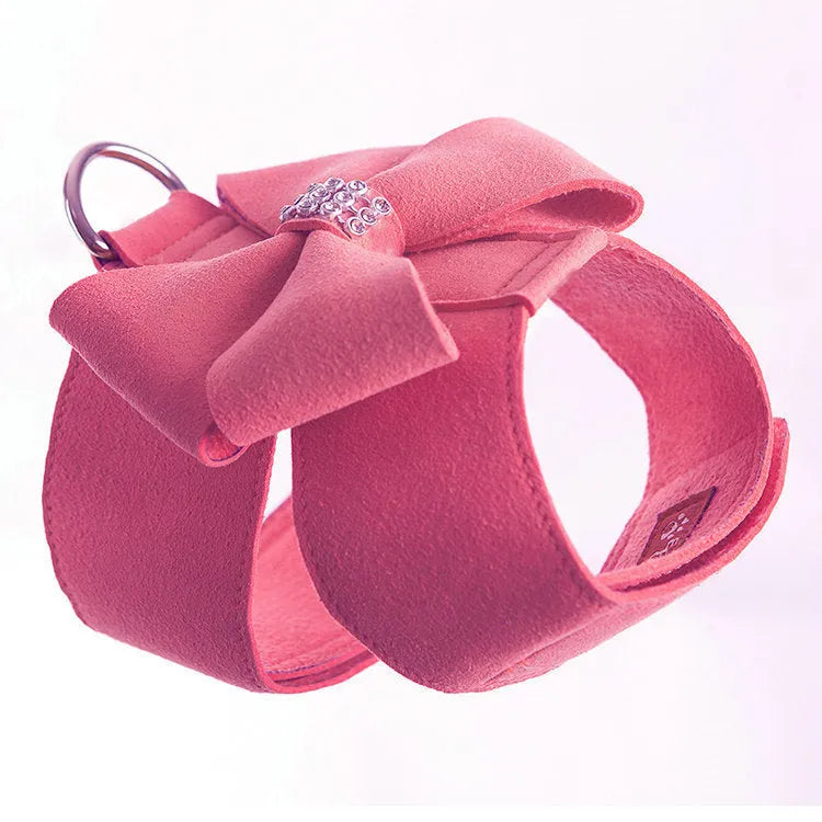 A pink microfiber dog chest strap with a large decorative bowknot, shown alongside blue and orange colour options.