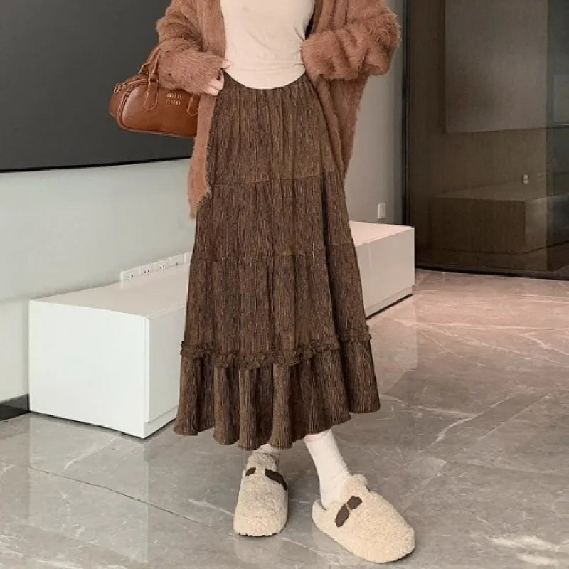 Corduroy A-line midi skirt with elastic waistband in beige, black or brown colours showing Korean style slimming silhouette