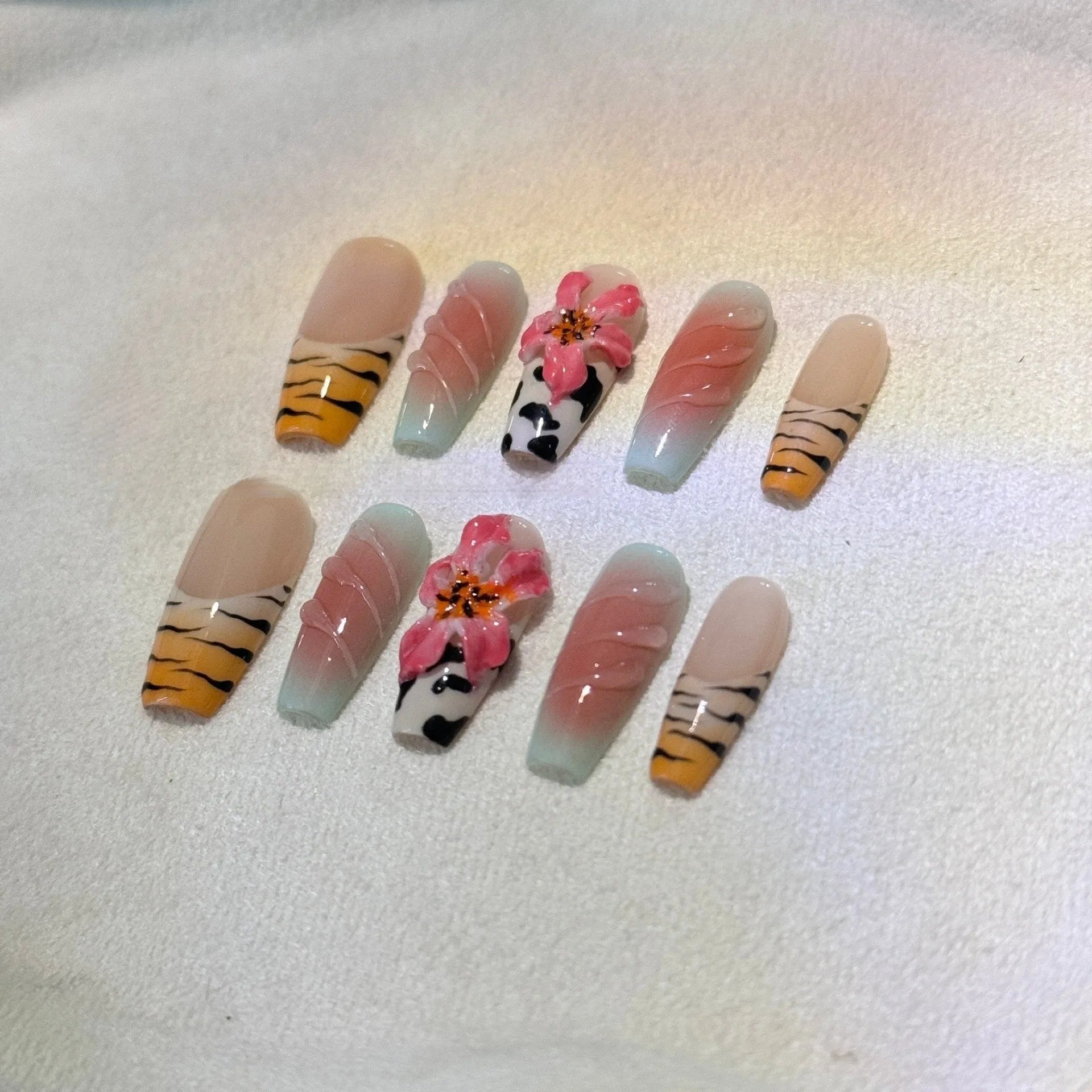 Zebra pattern lily hand carving nail art set showing flower, leopard print, and embossed designs in various sizes.