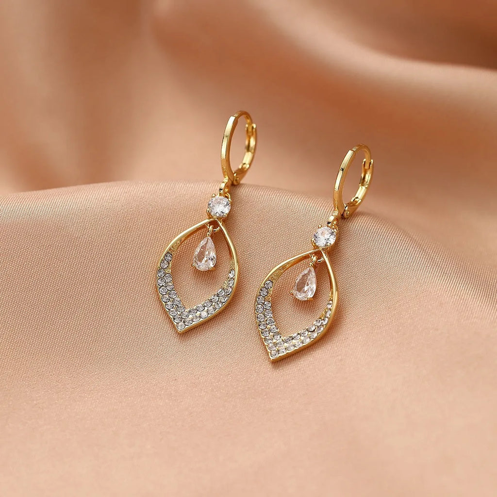 Gold and silver water drop tassel earrings with zircon stones on a copper base.