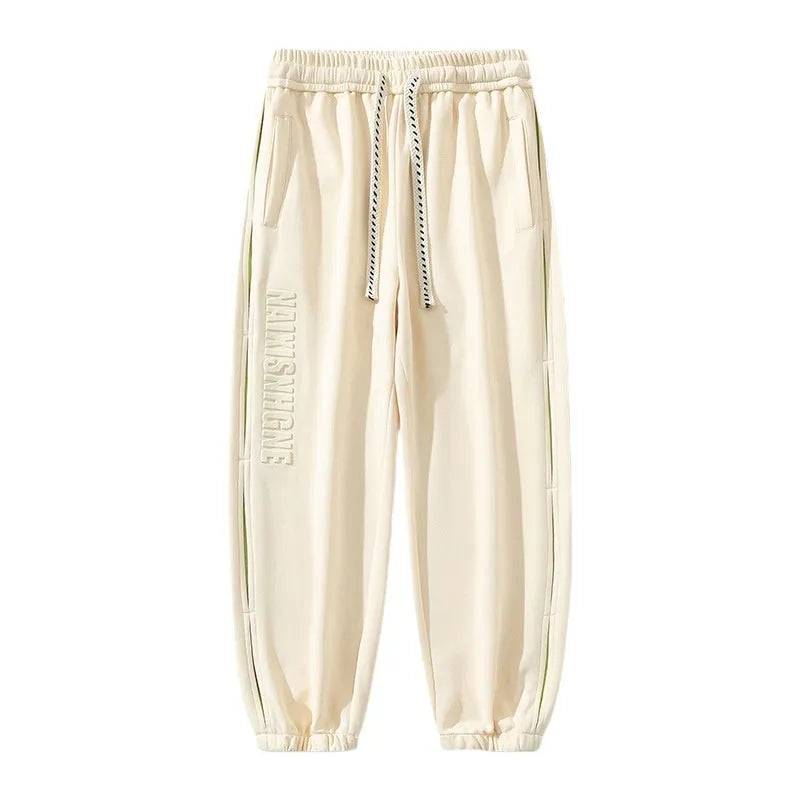 Men's loose fit cotton trousers with banded ankles and stitching details in grey green colour