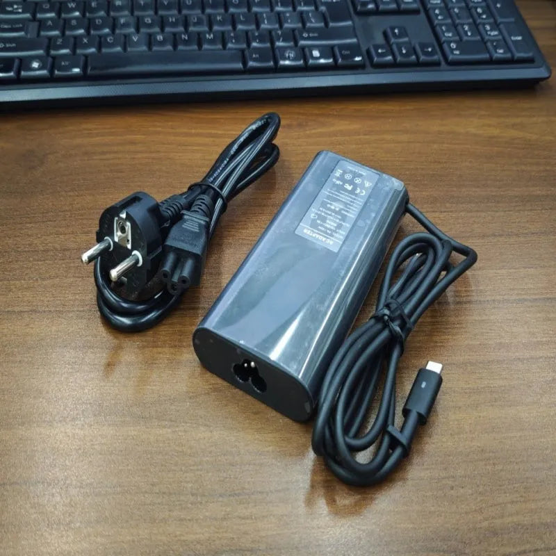 Black 65W Type-C laptop power adapter with multiple international power plugs