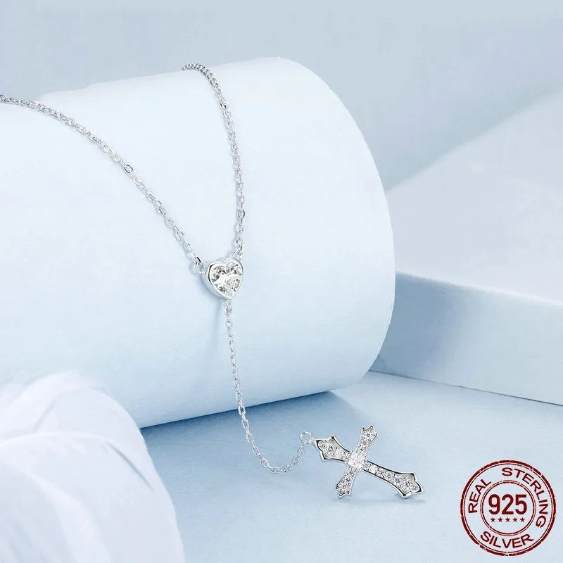 Simple sterling silver V-neck cross pendant on an O-ring chain necklace.