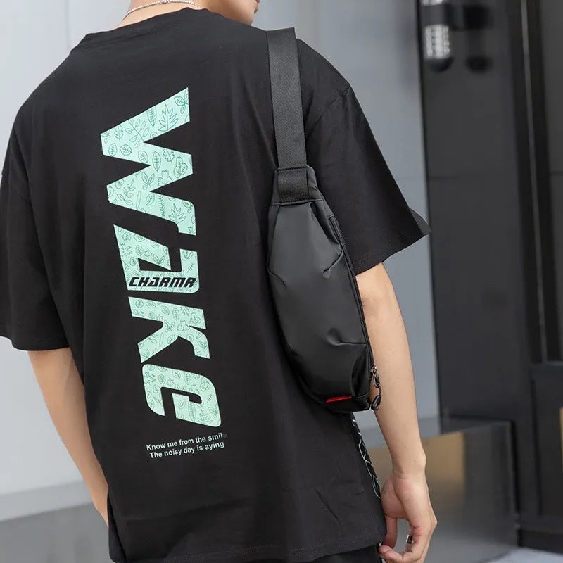 Black oxford cloth men's waist pack with crossbody strap, showing phone and ID pockets.