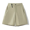 Men's khaki quick-drying sports shorts with 3D elastic cutting on a grey background.