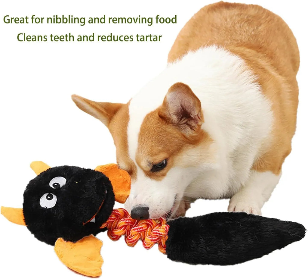 Large black plush dog toy with cartoon design, a rope knot, and a squeaker for chew play.