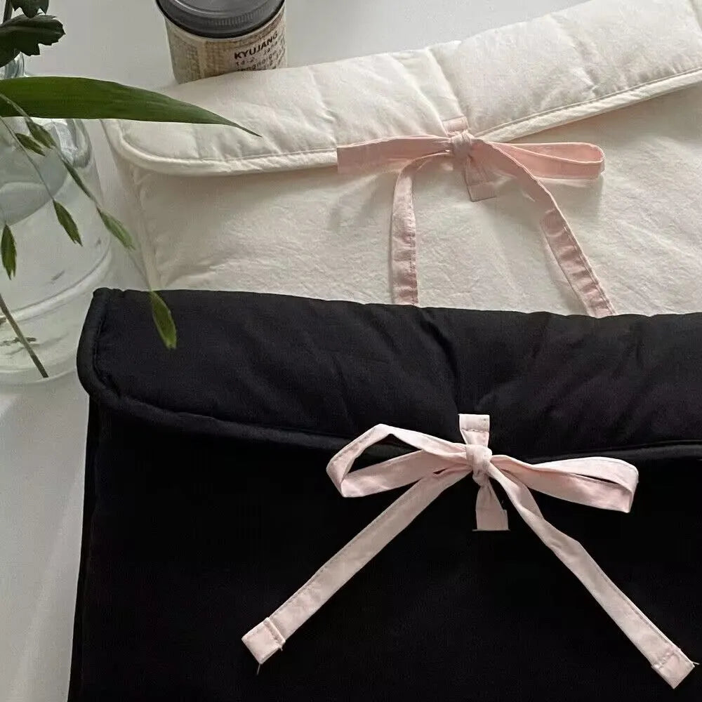 Women's black quilted laptop bag with ballet bow and striped pattern