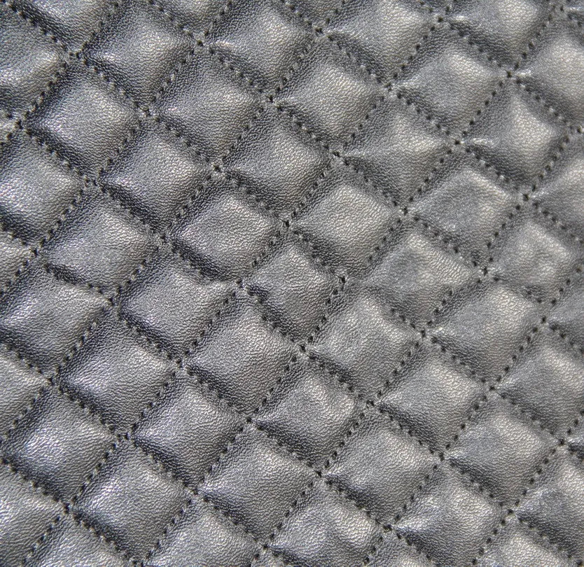 Black quilted automotive seat cover with PU and polyester construction showing plastic hooks