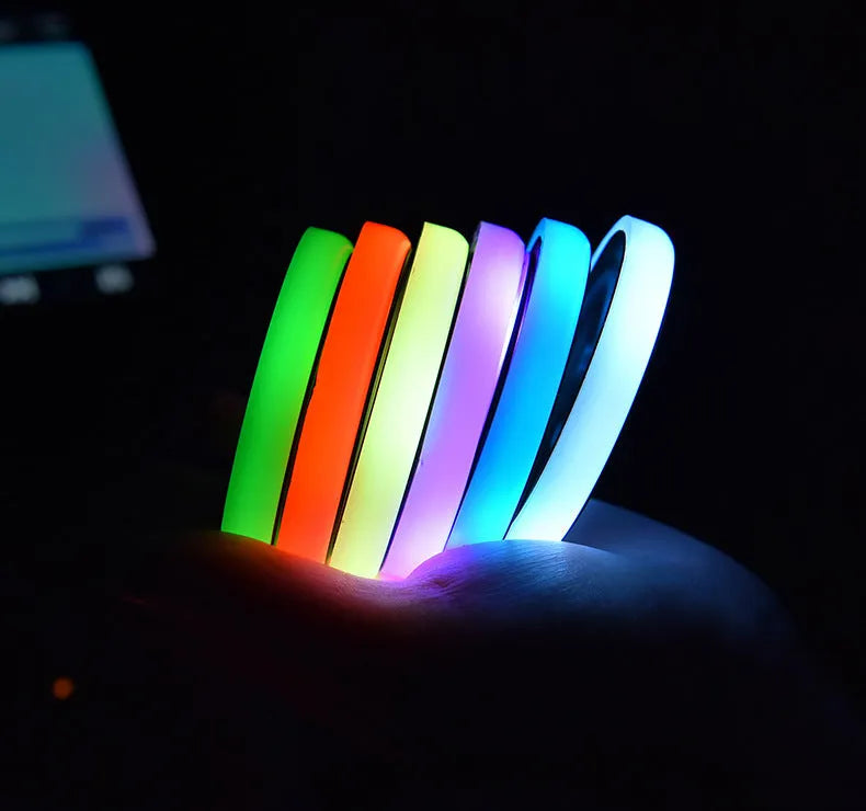 Colourful LED light-up car coaster with solar panel and USB cable on a car seat