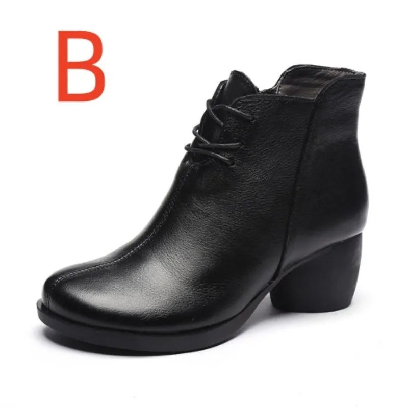 Women's black leather Martin ankle boots with a thick rubber heel and round toe.