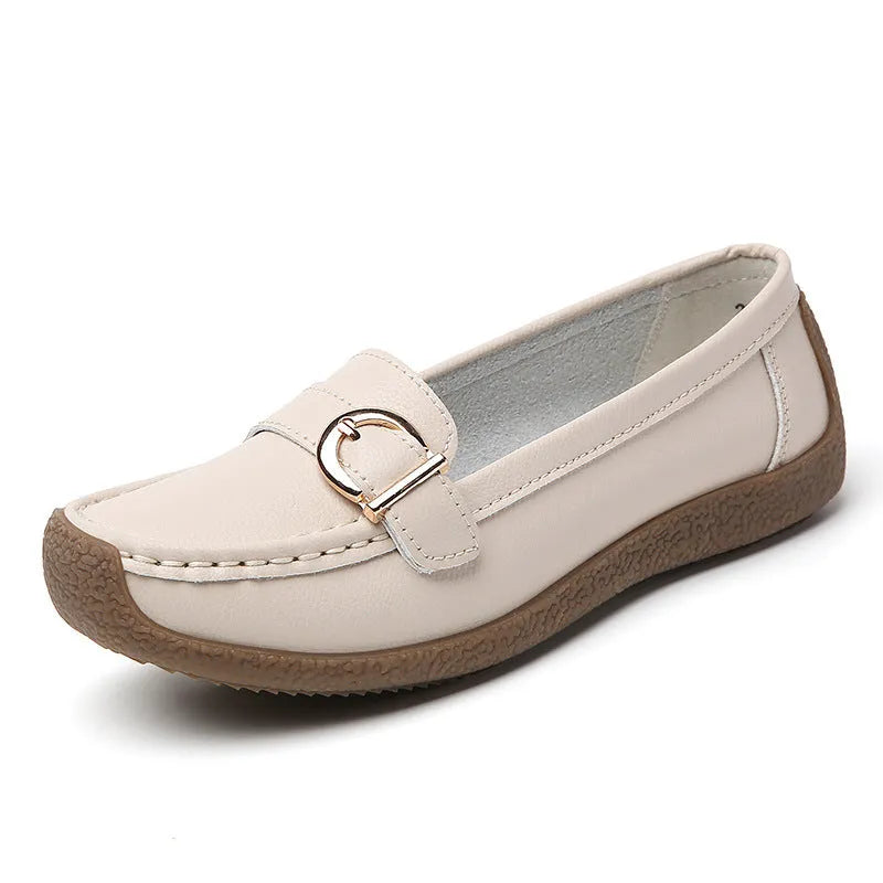 Women's beige loafers with round toe and flat heel on a light background