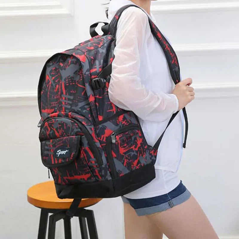 Blue and red large nylon backpack with multiple compartments open, showing internal organisation.