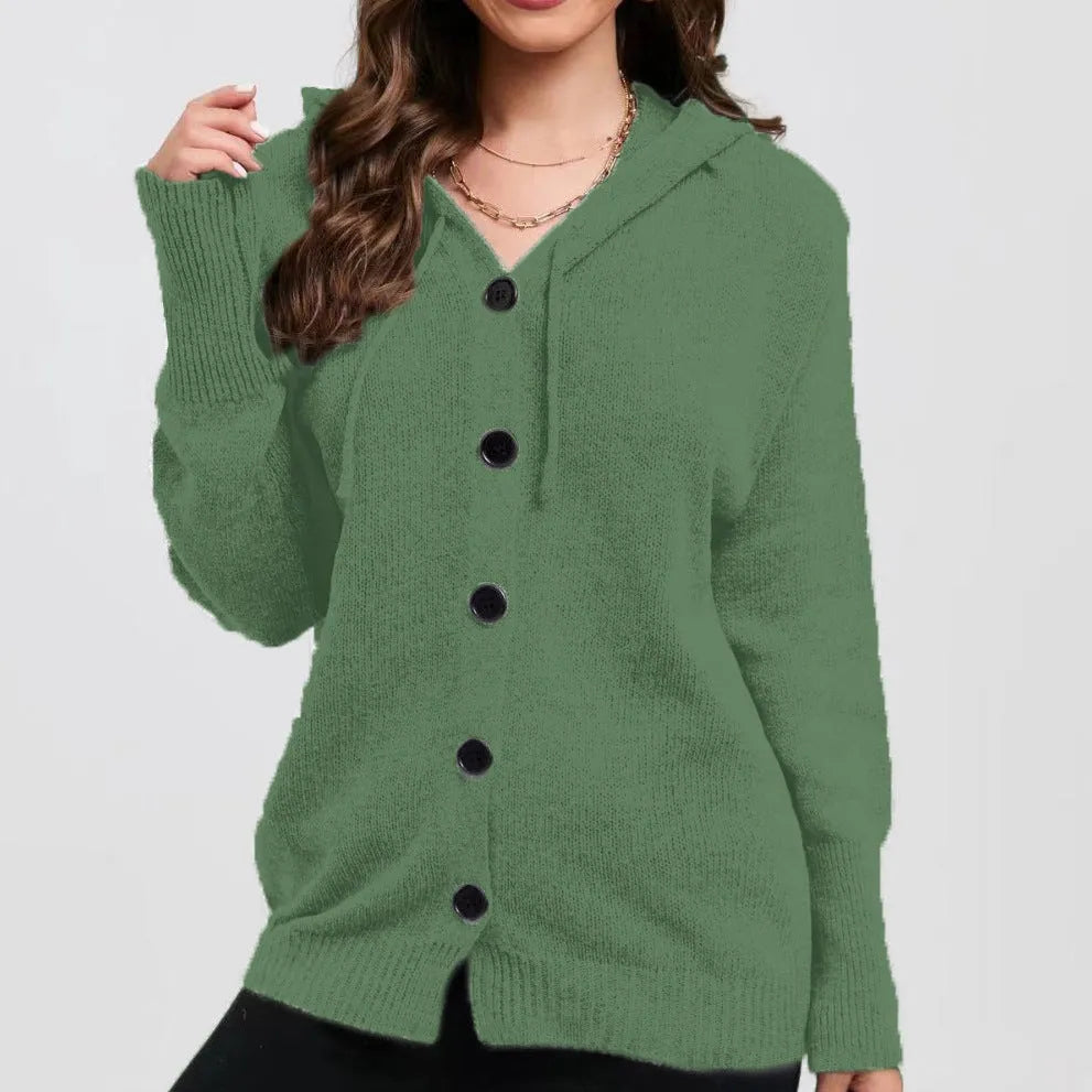 Woman wearing a thick army green zip-up hooded cardigan sweater with a loose fit.