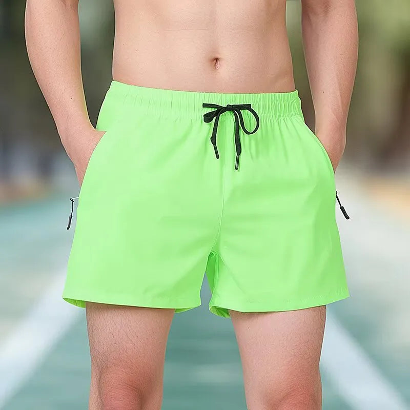 Man wearing black high-waisted Ice Silk polyester fitness shorts for running or gym training.