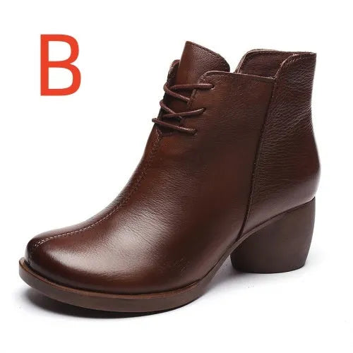 Women's black leather Martin ankle boots with a thick rubber heel and round toe.