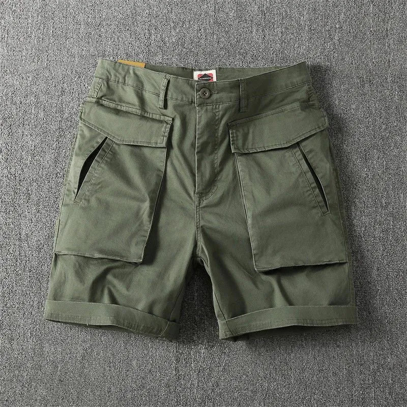 Men's army green cotton cargo shorts with multiple pockets, shown in a straight-leg summer street style.