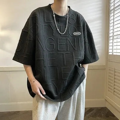 Men's grey short sleeve t-shirt with a raised white 3D letter pattern on the chest