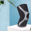 Red and grey knitted sports kneecaps with silicone grip panels for running and climbing activities