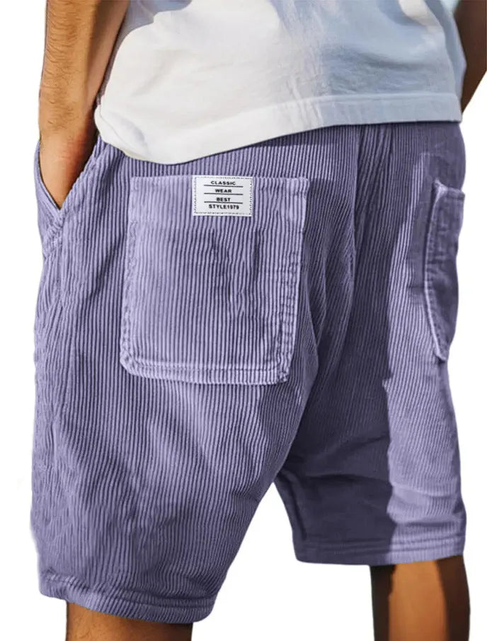 Men's grey corduroy shorts with embroidered detail on multiple pockets, laid flat.