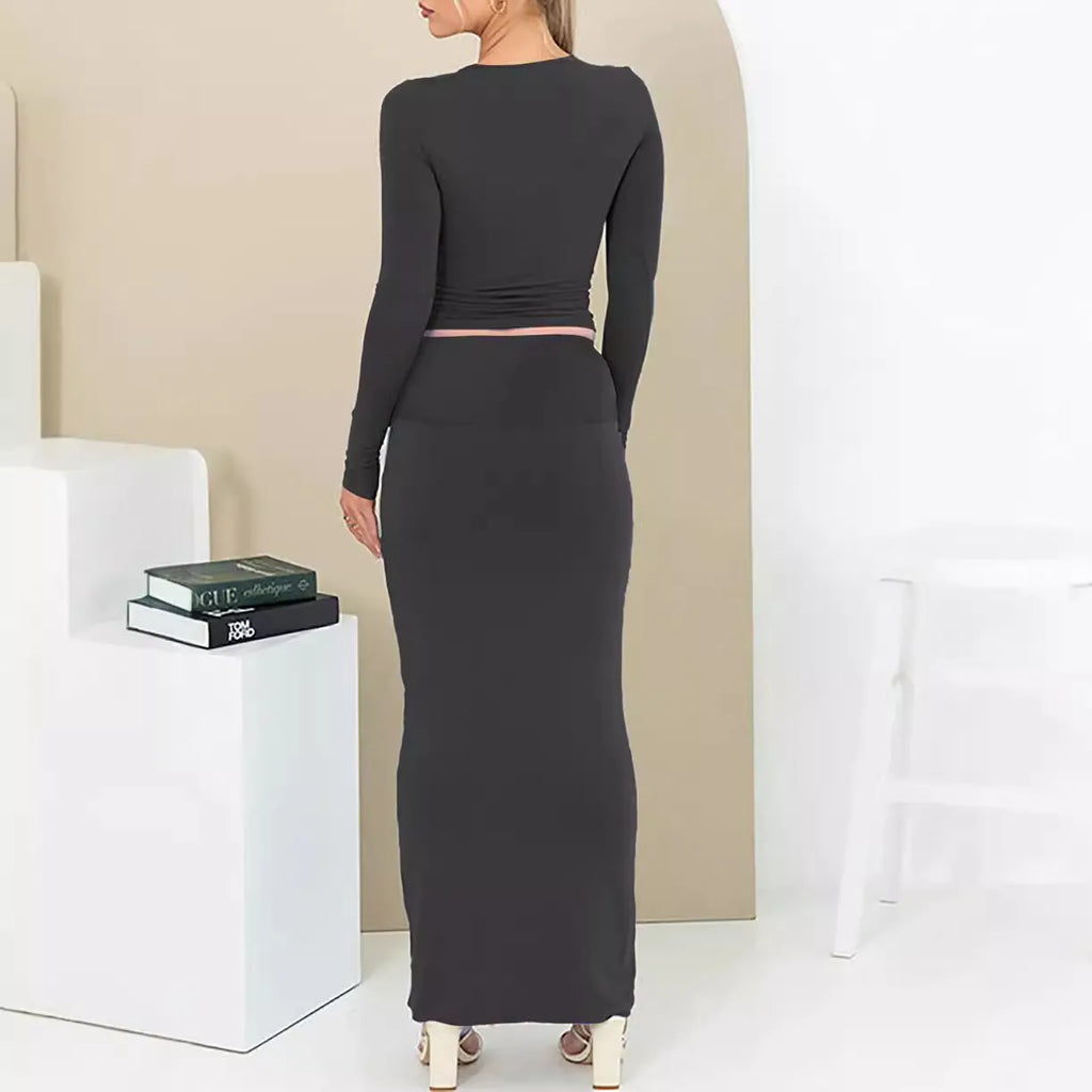 Women's black slim fit polyester two-piece suit with three-quarter sleeve top and long skirt.