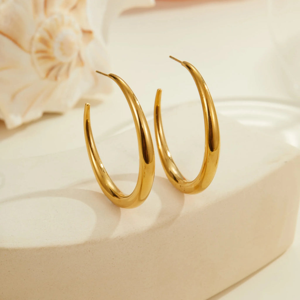 Geometric round stainless steel hoop earrings with gold plating, shown in large and small sizes.
