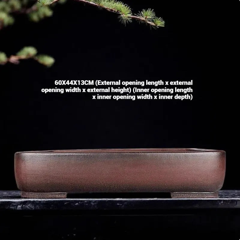 Handmade antique rectangular purple clay flower pot on tabletop
